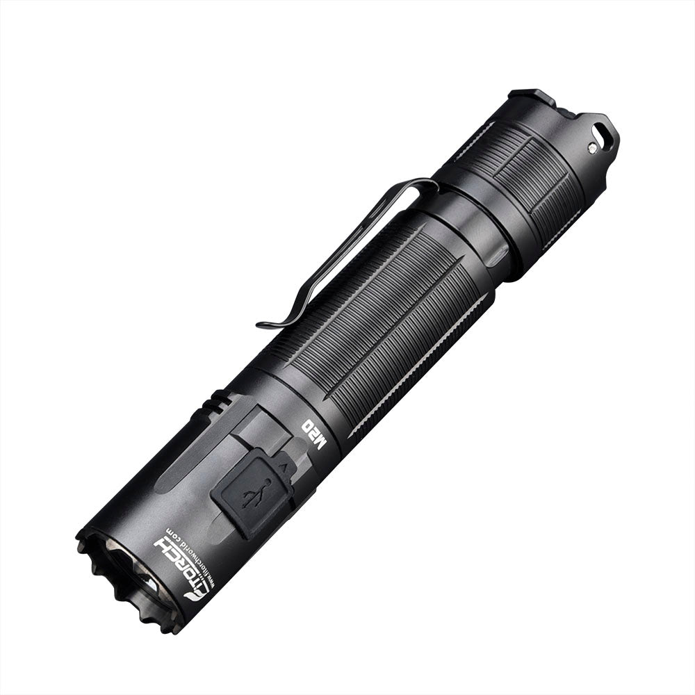 Fitorch M20 black tactical flashlight angled to show the clip and covered USB charging port