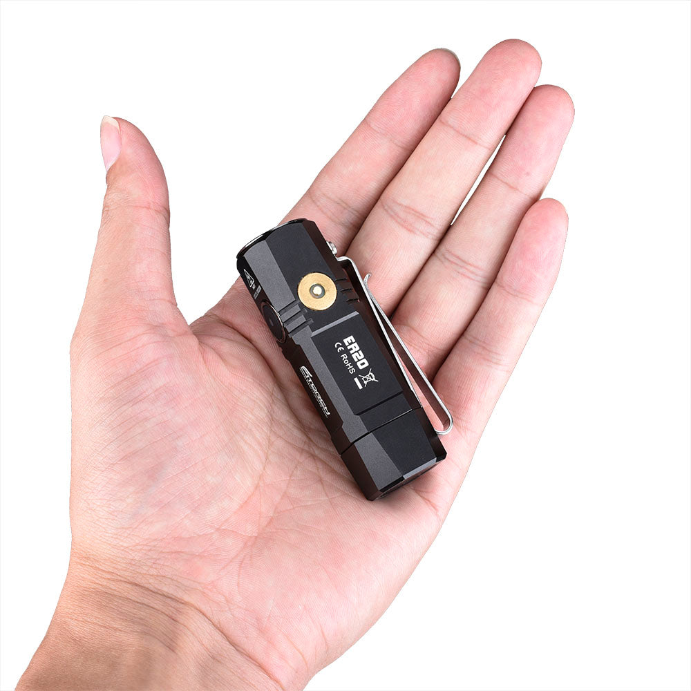 Fitorch ER20 black mini flashlight resting in a palm to show its compact size