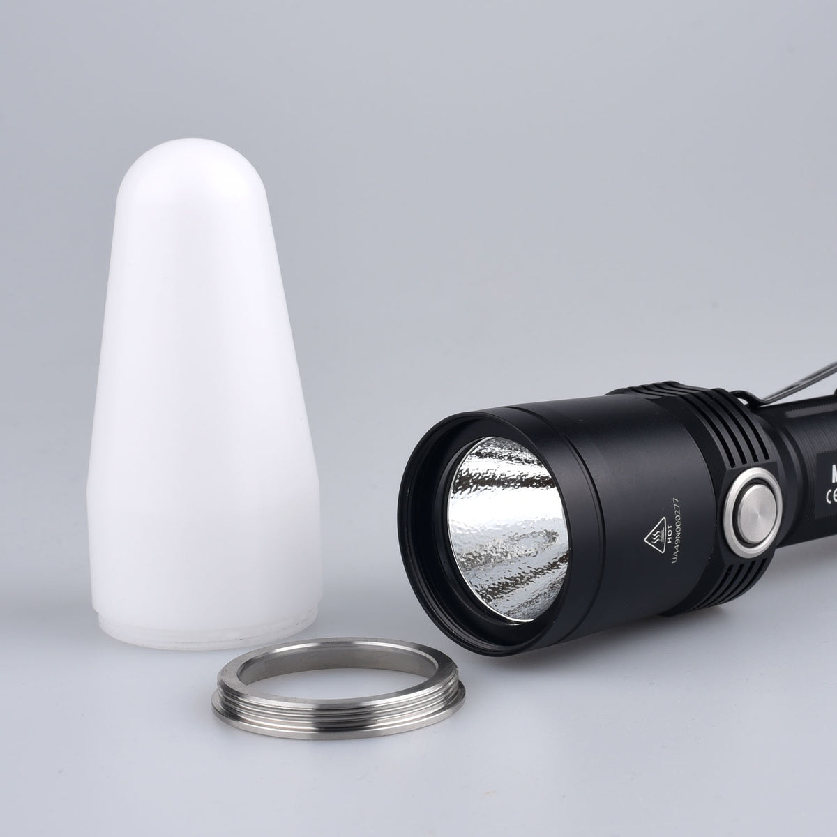 Fitorch DF35 white diffuser beside the MR35 flashlight head and removed metal bezel