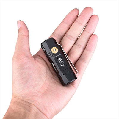 Fitorch ER20 black mini flashlight resting in a palm to show its compact size